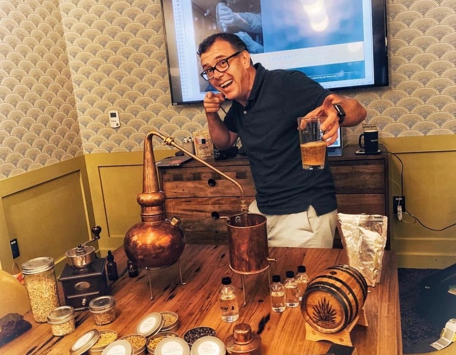 Whisky education setup with numbered samples, bottles and a miniature copper still